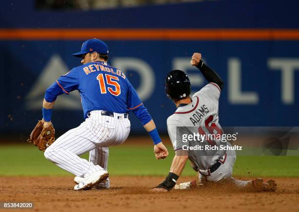 Lane Adams of the Atlanta Braves steals second base before shortstop Matt Reynolds of the New York Mets can make a tag in the during the third inning...