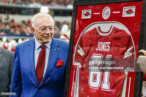 Dallas Cowboys owner Jerry Jones gets a Arkansas Razorbacks Jersey for the 1961 Arkansas National Championship team during the game between the...