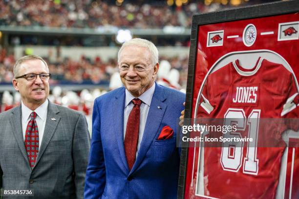 Dallas Cowboys owner Jerry Jones gets a Arkansas Razorbacks Jersey for the 1961 Arkansas National Championship team during the game between the...