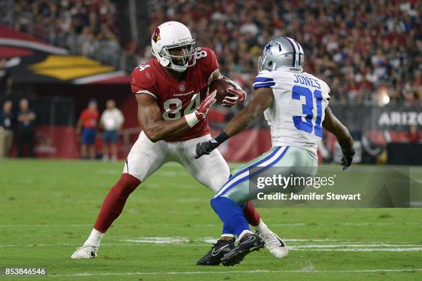 Tight end Jermaine Gresham of the Arizona Cardinals runs past free safety Byron Jones of the Dallas Cowboys during the first half of the NFL game at...