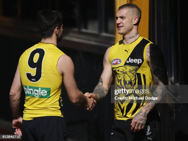 Dustin Martin is congratulated by Trent Cotchin after winning the Brownlow medal last night ahead of the Richmond Tigers AFL training session at Punt...