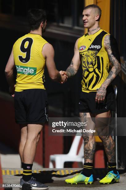 Dustin Martin is congratulated by Trent Cotchin after winning the Brownlow medal last night ahead of the Richmond Tigers AFL training session at Punt...