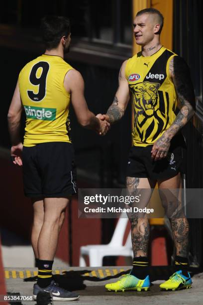 Dustin Martin is congratulated by Trent Cotchin after winning the Brownlow medal last night ahead of the Richmond Tigers AFL training session at Punt...