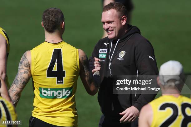 Dustin Martin is congratulated by assistant coach Justin Leppitsch after winning the Brownlow medal last night ahead of the Richmond Tigers AFL...