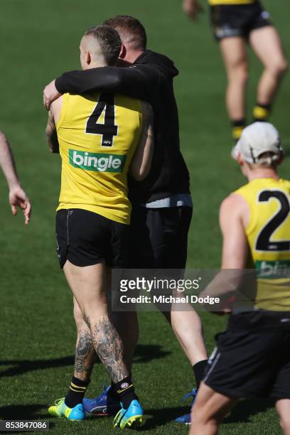 Dustin Martin is congratulated by assistant coach Justin Leppitsch after winning the Brownlow medal last night ahead of the Richmond Tigers AFL...