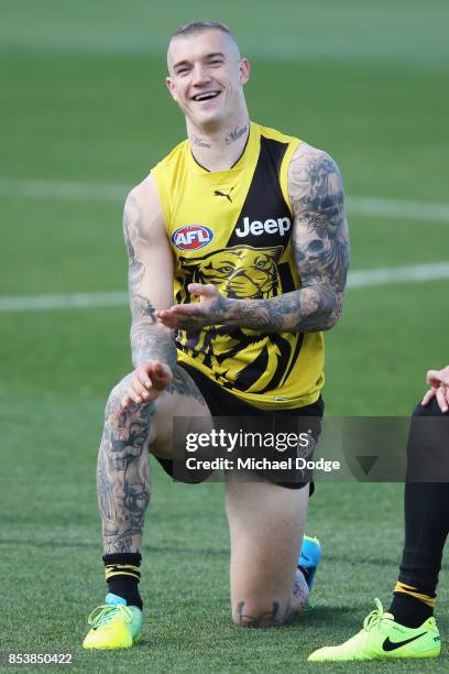 Dustin Martin, a winner of the Brownlow medal last night, reacts ahead of the Richmond Tigers AFL training session at Punt Road Oval on September 26,...