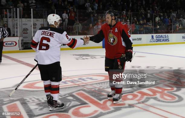 Andy Greene of the New Jersey Devils shakes hands with Dion Phaneuf of the Ottawa Senators following the game during Kraft Hockeyville Canada on...