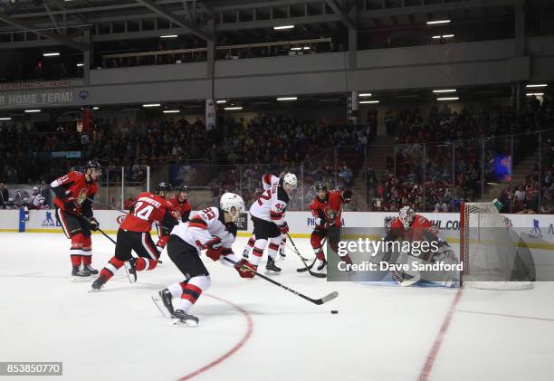 Andrew Hammond of the Ottawa Senators moves into position as Jesper Bratt of the New Jersey Devils carries the puck to the net during Kraft...