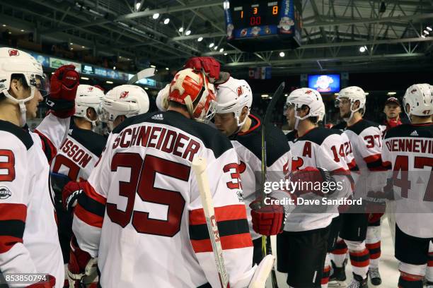 Dalton Prout of the New Jersey Devils celebrates his teams win over the Ottawa Senators with teammate Cory Schneider of the New Jersey Devilsduring...