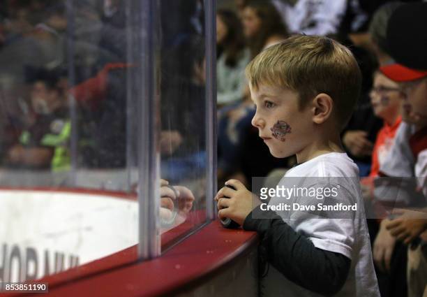 Fan watches the New Jersey Devils take on the Ottawa Senators during Kraft Hockeyville Canada on September 25, 2017 at Credit Union Place in...