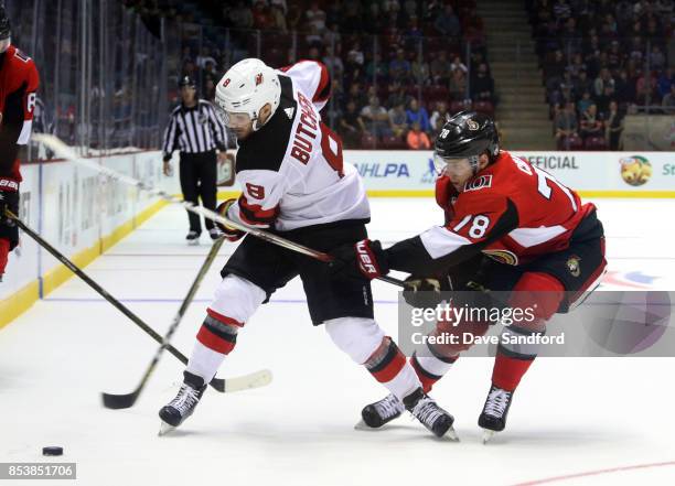 Filip Chlapik of the Ottawa Senators backchecks against Will Butcher of the New Jersey Devils during Kraft Hockeyville Canada on September 25, 2017...