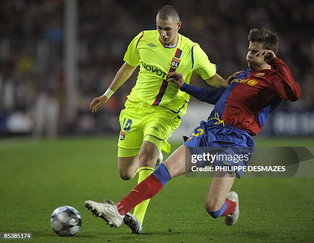 Lyon's forward Karim Benzema is tackled by Barcelona's defender Gerard Pique during their Champions League football match at the Camp Nou stadium in...