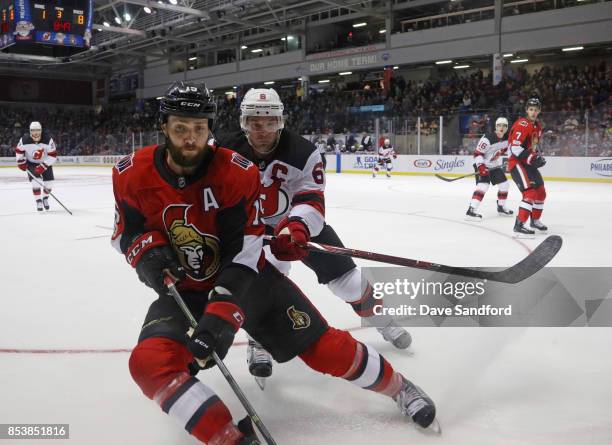 Zack Smith of the Ottawa Senators battles for a loose puck with Andy Greene of the New Jersey Devils during Kraft Hockeyville Canada on September 25,...