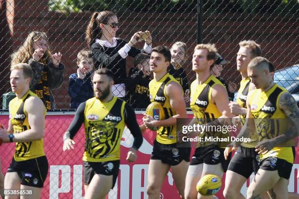 Locked out fans get a glimpse during a Richmond Tigers AFL training session at Punt Road Oval on September 26, 2017 in Melbourne, Australia.