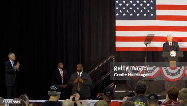 Vice President Mike Pence speaks at a campaign rally as Sen. Luther Strange applauds at HealthSouth Aviation on September 25, 2017 in Birmingham,...