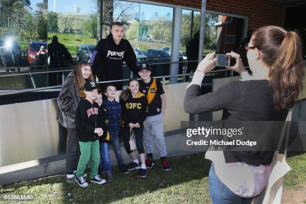 Dustin Martin, a winner of the Brownlow medal last night, poses with young Tigers fans ahead of the Richmond Tigers AFL training session at Punt Road...