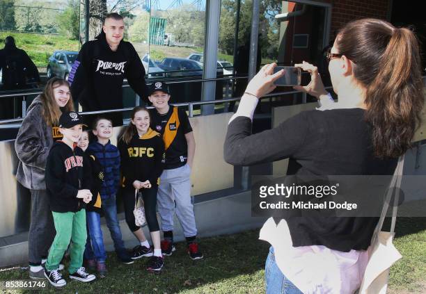 Dustin Martin, a winner of the Brownlow medal last night, poses with young Tigers fans ahead of the Richmond Tigers AFL training session at Punt Road...