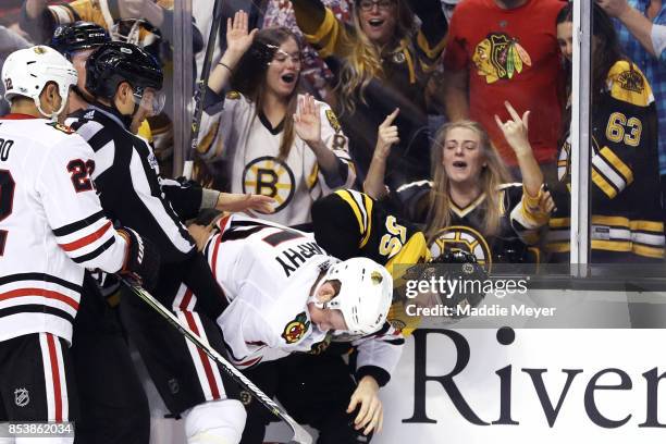 Noel Acciari of the Boston Bruins and Connor Murphy of the Chicago Blackhawks fight during the third period of their preseason game at TD Garden on...