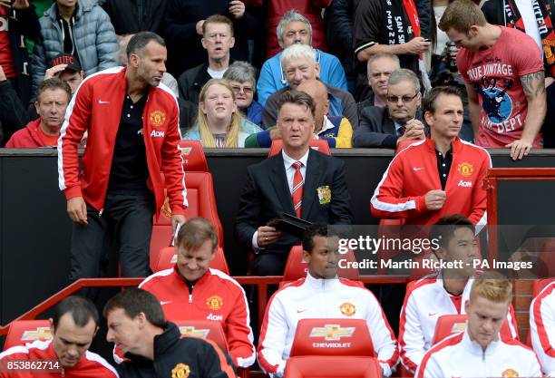 Manchester United manager Louis van Gaal takes his seat on the bench next to his assistant Ryan Giggs and coach Albert Stuivenberg before the...