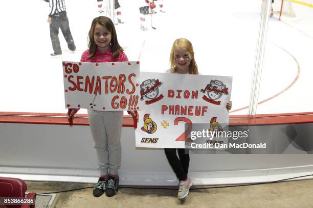 Two young fans proudly pose with the signs they made for the 2017 Kraft Hockeyville Canada game between the New Jersey Devils and Ottawa Senators at...