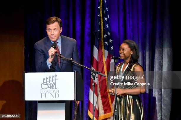 Master of Ceremonies Bob Costas and GSLD Honoree Simone Biles speak onstage at the 32nd Annual Great Sports Legends Dinner To Benefit The Miami...