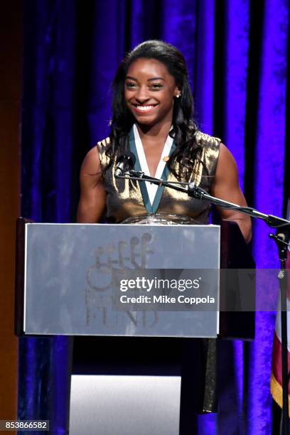 Honoree Simone Biles speaks onstage at the 32nd Annual Great Sports Legends Dinner To Benefit The Miami Project/Buoniconti Fund To Cure Paralysis at...