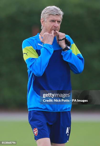 Arsenal manager Arsene Wenger directs his players during a training session at London Colney, Hertfordshire.