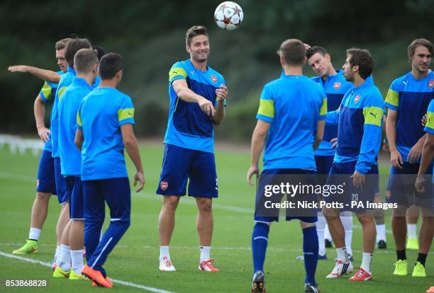 Arsenal's Olivier Giroud laughs as the ball hits his head, in jest, during a training session at London Colney, Hertfordshire.