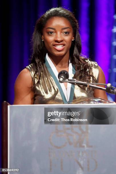 Simone Biles speaks onstage during the 32nd Annual Great Sports Legends Dinner To Benefit The Miami Project/Buoniconti Fund To Cure Paralysis at New...