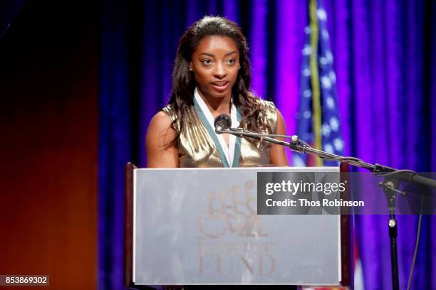 Simone Biles speaks onstage during the 32nd Annual Great Sports Legends Dinner To Benefit The Miami Project/Buoniconti Fund To Cure Paralysis at New...