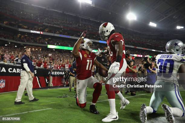 Running back Andre Ellington of the Arizona Cardinals and wide receiver Larry Fitzgerald react after scoring a 15 yard touchdown during the third...