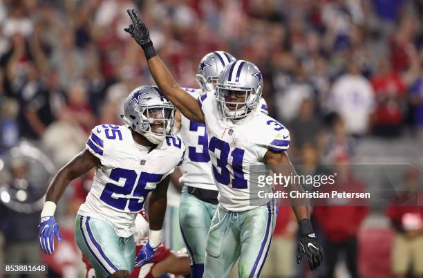 Free safety Byron Jones of the Dallas Cowboys reacts with safety Xavier Woods of the Dallas Cowboys after breaking up a fourth down pass during the...