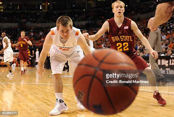 Guard Keiton Page of the Oklahoma State Cowboys watches the ball fall out of bounds with Bryan Petersen of the Iowa State Cyclones during the...