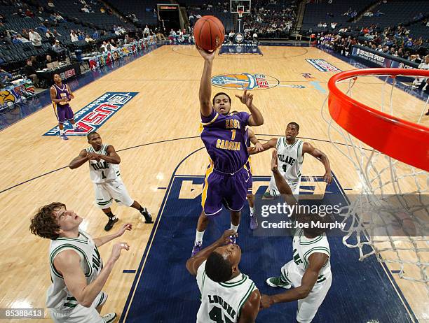 Darrius Morrow of the East Carolina Pirates shoots over Robinson Louisme of the Tulane Green Wave during Round One of the Conference USA Basketball...