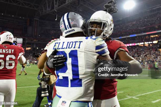 Running back Ezekiel Elliott of the Dallas Cowboys and outside linebacker Markus Golden of the Arizona Cardinals embrace after the NFL game at the...