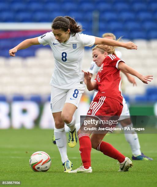 Wales' Sarah Wiltshire tackles England's Karen Carney during the FIFA Womens World Cup Qualifying Group Six match at Cardiff City Stadium, Cardiff.