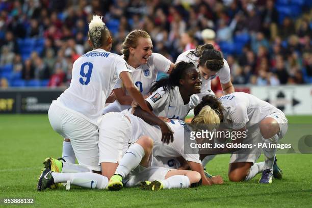 England's Laura Bassett is mobbed by her teammates after scoring the third goal during the FIFA Womens World Cup Qualifying Group Six match at...