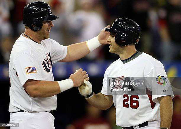 Adam Dunn of the USA congratulates Chris Iannetta after Iannetta hit a two run home run during the 2009 World Baseball Classic Pool C match at the...