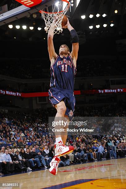 Brook Lopez of the New Jersey Nets dunks against the Golden State Warriors on March 11, 2009 at Oracle Arena in Oakland, California. NOTE TO USER:...