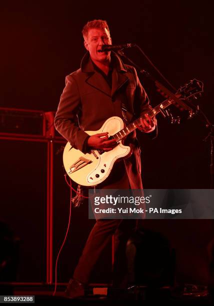 Josh Homme of Queens of the Stone Age performing on the Main Stage, at the Reading Festival, at Little John's Farm on Richfield Avenue, Reading.