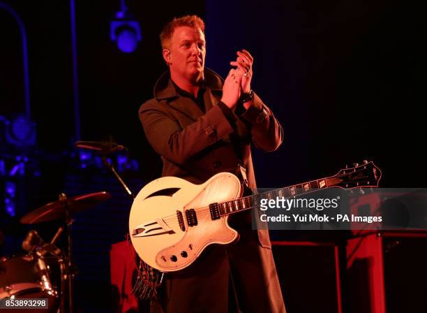 Josh Homme of Queens of the Stone Age performing on the Main Stage, at the Reading Festival, at Little John's Farm on Richfield Avenue, Reading.