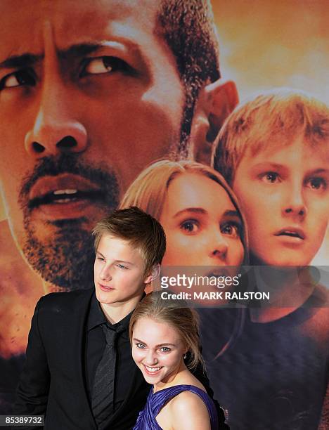 Actor Alexander Ludwig and co-star AnnaSophia Robb pose for photos as they arrive for the world premiere of the Disney film "Race to Witch Mountain"...