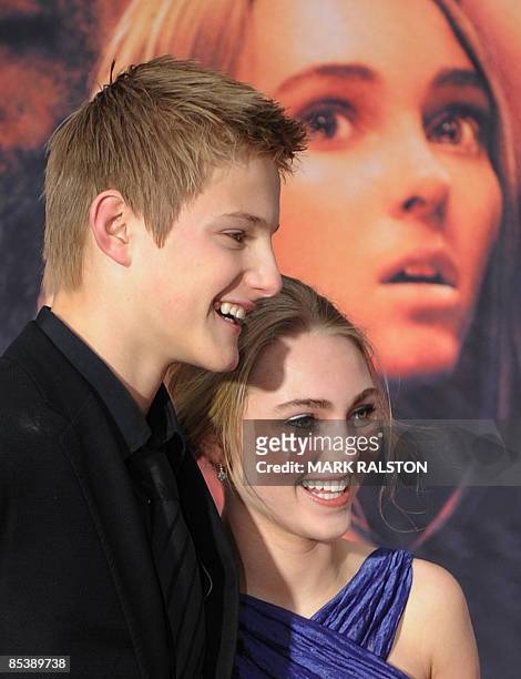 Actor Alexander Ludwig and co-star AnnaSophia Robb pose for photos as they arrive for the world premiere of the Disney film "Race to Witch Mountain"...