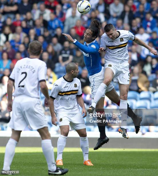 Rangers' Bilel Mohsni and Dumbarton's Colin Nish attempt to head the ball during the Scottish Championship match at Ibrox Stadium, Glasgow.