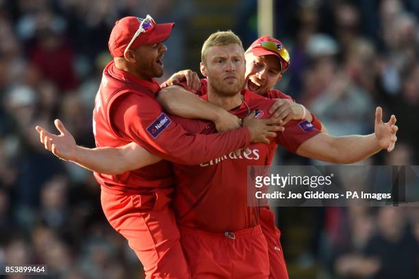 Lancashire Lightning's Andrew Flintoff celebrates with Ashwell Prince and Steven Croft after taking the wicket of Birmingham Bears' Ian Bell with his...