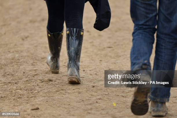Festival goers walk through mud during day three of Leeds Festival in Bramham Park, Leeds.