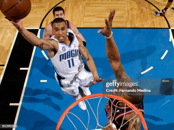 Courtney Lee of the Orlando Magic shoots against Tyrus Thomas of the Chicago Bulls during the game at Amway Arena March 11, 2009 in Orlando, Florida....