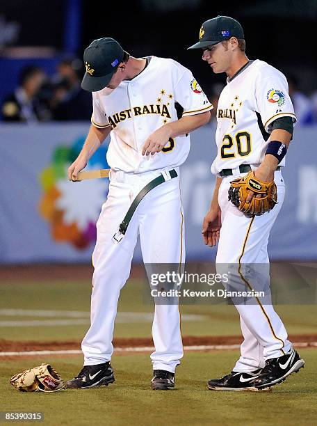 James Breseford of Australia replaces his belt after breaking it during a groundout by Mexico during the 2009 World Baseball Classic Pool B match on...