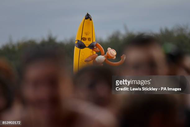 Festival goer holds up an inflatable banana and monkey in the crowd during day three of Leeds Festival in Bramham Park, Leeds.