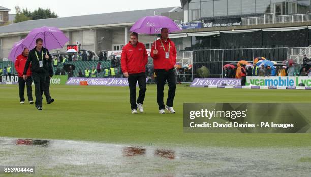 Umpires inspect the outfield as rain abandons play at the Royal London One Day International at the Bristol County Ground, Bristol.